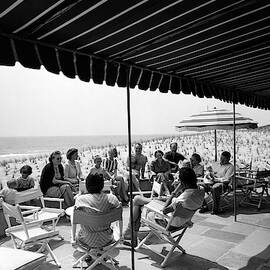 A Group Of People On A Terrace Overlooking by Tom Leonard