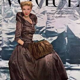 A Vogue Cover Of A Woman Wearing A Brown Dress by Erwin Blumenfeld