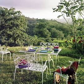 Outdoor Furniture By Lloyd On Grassy Hillside by Tom Leonard